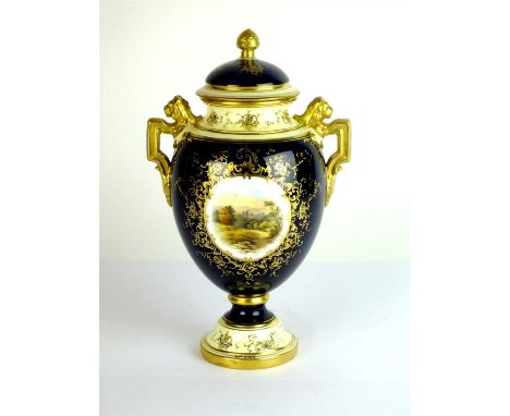 A Coalport twin-handled 'Naworth Castle' landscape vase and cover circa 1900 with figural lion handles and an overall cobalt 
