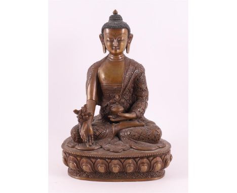 A bronze seated Buddha in lotus position on lotus crown, India 20th century, h 21 cm.