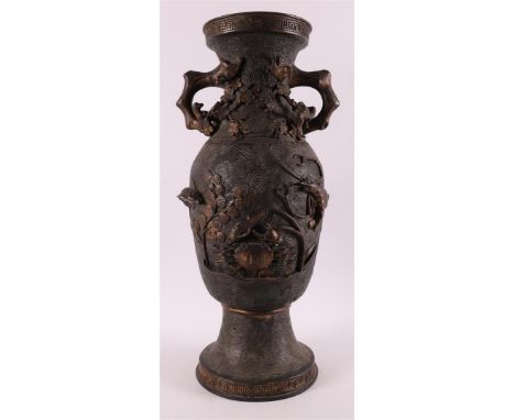 A brown patinated bronze baluster-shaped vase with handles, China, around 1900. Relief decor of animal figures and landscape,