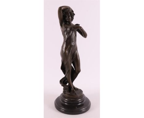 A brown patinated bronze sculpture of a woman with a draped dress, on a black marble base, after an antique example, 21st cen
