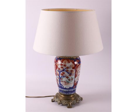 A porcelain Imari lamp base with brass frame, Japan, Meiji, around 1900. Blue/red, partly gold heightened floral decor, shade