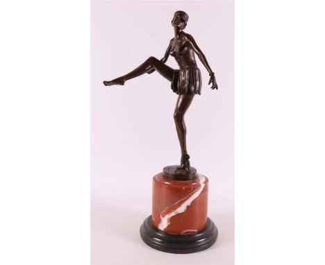 A brown patinated bronze Art Deco sculpture of a dancer with skirt, on a black marble base, after an antique example, 21st ce