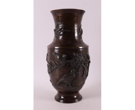 A brown patinated bronze vase, Japan, Meiji, early 20th century. Relief decor of birds and prunus, h 30.5 cm.