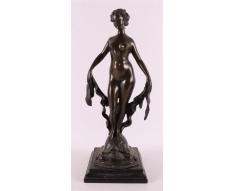 A brown patinated bronze sculpture of a female nude on tortoiseshell on a black marble base, after an antique example, 21st c