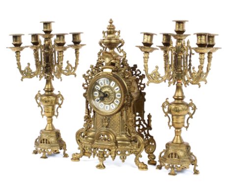 A French gilt-metal three piece clock garniture, 20th century, the mantle clock with white enamelled Roman numeral chapter di