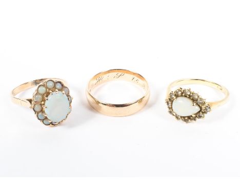 A 15ct gold wedding band together with a 15ct gold opal ring and  an unmarked yellow metal opal ring. 8.8g. 