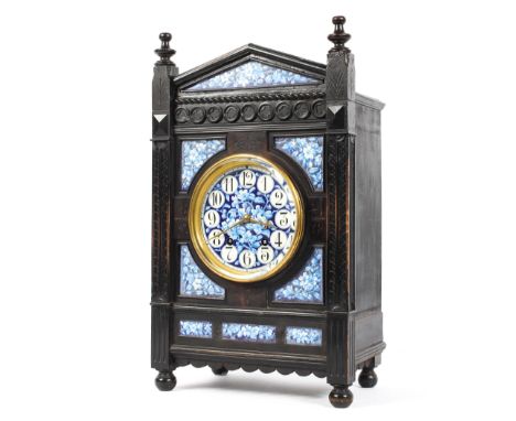 A Victorian Aesthetic Movement ebonised and enamelled striking mantle clock, of arched architectural form, the enamelled dial