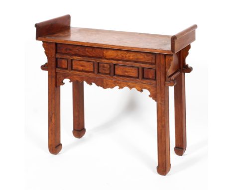 A Chinese hardwood carved altar table, 20th century, of traditional slim form, with curved top above carved scroll apron and 