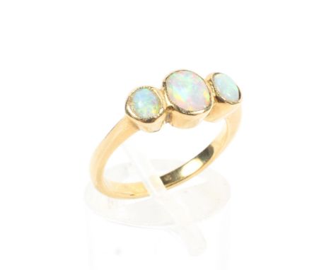 An unmarked yellow metal opal three stone ring. 3.4g.  Size K. 