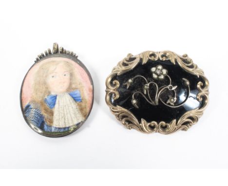 A black enamel and gilt metal mourning brroch set with seed pearl flowers and rose cut diamond accent together with an oval p