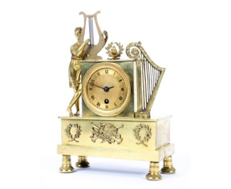 An Empire style gilt-metal mantel clock, late 19th/early 20th century, mounted with a classical figure with a lyre beside a s