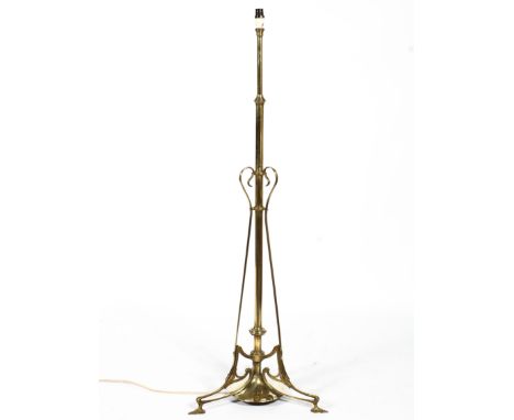An Art Nouveau brass floor lamp in the manner of WAS Benson, circa 1900, adapted for electricity, original with oil lamp rese