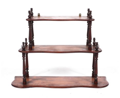 A Victorian mahogany hanging three tier shelf, of serpentine outline, 47 cm high x 59 cm wide x 20 cm deep 