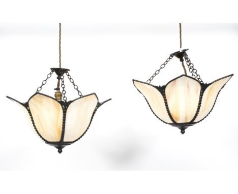 A pair of Edwardian petal shaped opaque pendant lights, each cast with beeded and floral frames, issuing a single light, susp