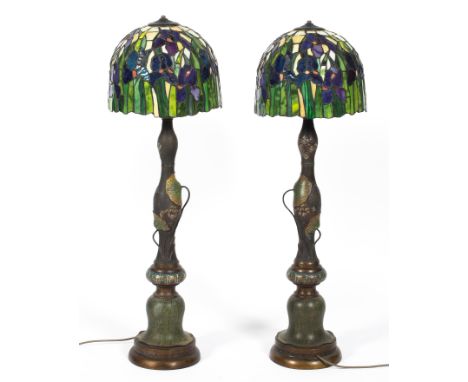 A pair of Chinese cloisonne lamp bases and Tiffany style glass shades, the first circa 1900, the shades 20th century, the bal