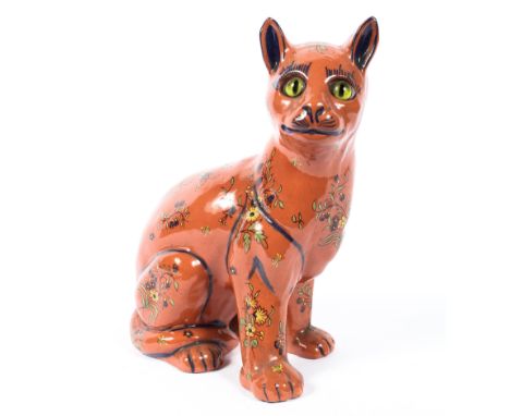 A Continental faience model of a seated cat in the manner of Galle, 20th century, with glass eyes and floral decoration, pain
