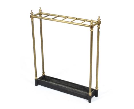 A Victorian brass stick stand, with waisted finials and six brass divisions to top, with cast iron rectangular trough base, 6