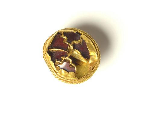 Anglo-Saxon gold and garnet scabbard fitting. A circular gold button with a twisted gold wire border and cloisonné cells for 