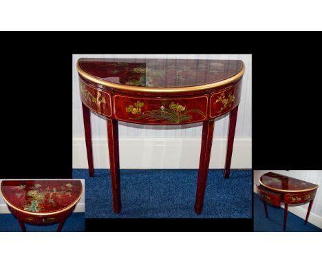 A Decorative Chinese Console Table Crescent form table with central front drawer, the whole finished in red and black faux la