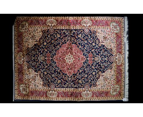 A Large Woven Silk Carpet Keshan rug with midnight blue ground and traditional Middle Eastern floral and foliate border detai