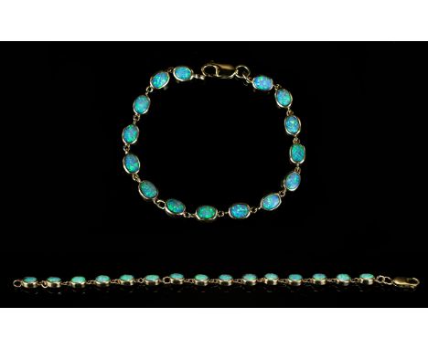 9ct Gold - Nice Quality Opal Set Bracelet, Set with 15 Opals of Good Colour. Hallmarked for 9ct Gold. 7.5 Inches In length. 9