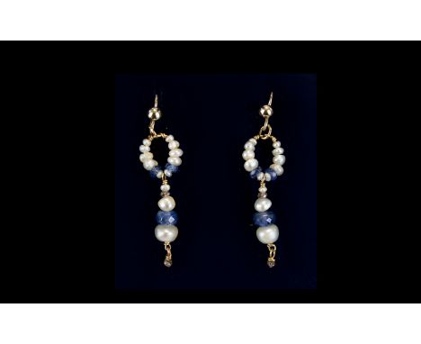 A Pair of Antique Pearl Drop Earrings. Delicate wired earrings fashioned from seed pearls and faceted blue glass seed bead de