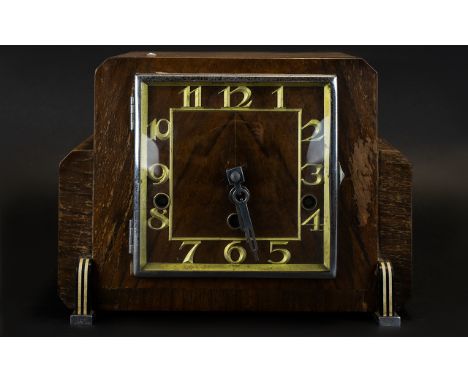 Art Deco Mantle Clock Square wooden cased clock of typical form with brass numerals and silver tone hands. 8.5 inches high, 9