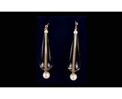 A Pair of Victorian Gold Drop Earrings. Wired earrings fashioned with smoky topaz tone teardrop glass beads and pearl drops t