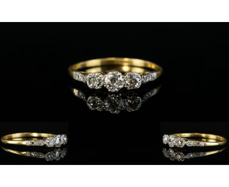 18ct Gold and Platinum 3 Stone Diamond Ring. The 3 Cushion Cut Diamonds of Good Colour, with A Further 4 Cushion Cut Diamonds