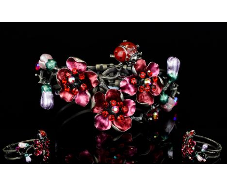 A Floral And Crystal Set Statement Cuff Hinged cuff bracelet in pewter tone metal profusely decorated with applied floral det