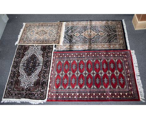 A Collection Of Four Indian Carpets Four woven carpets each in traditional Anglo Indian and Persian style. To include large h