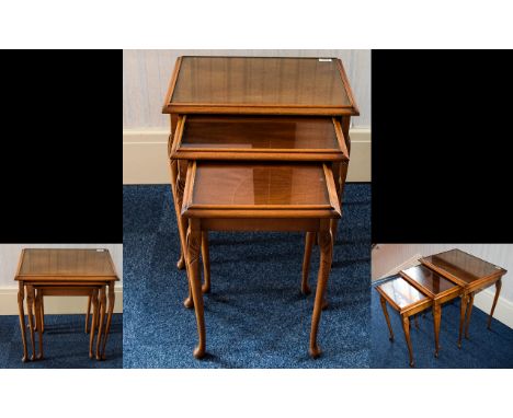 Nest of Tables three in total. Of square form in light wood with glass top and carved Queen Anne Legs. Height of the tallest 