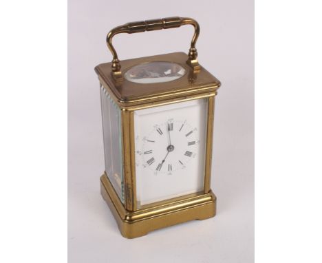A brass cased carriage clock with white enamel dial and Roman numerals, 5 1/2" high