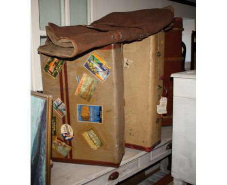 A wood banded travel trunk with lift-out tray, two vintage suitcases with original travel labels and a part leather suit carr