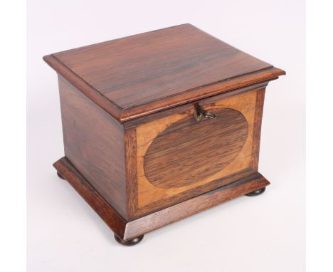 A rosewood single compartment tea caddy on bun feet, 5 1/2" wide