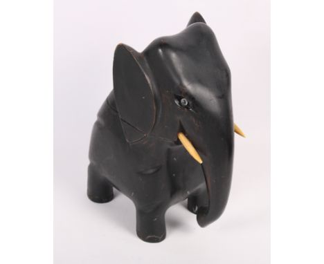 An ebonised novelty tea caddy formed as an elephant, 9" high