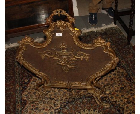 A brass framed Rococo design scrollwork firescreen, 28" wide
