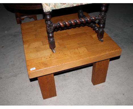 A light oak low coffee table, on square supports, 31" wide