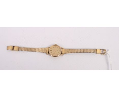 A lady's Mappin & Webb 9ct gold cased manual wind wristwatch with gilt dial and baton numerals, on gilt metal strap