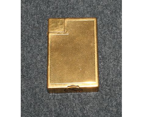 A Dunhill gold plated and engine turned cigarette lighter