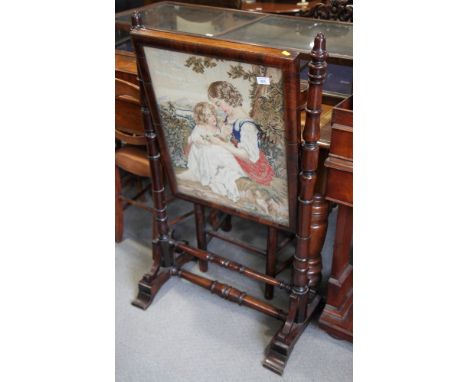 A mid 19th Century rosewood framed firescreen with needlepoint panel, on turned splay supports, 26" wide