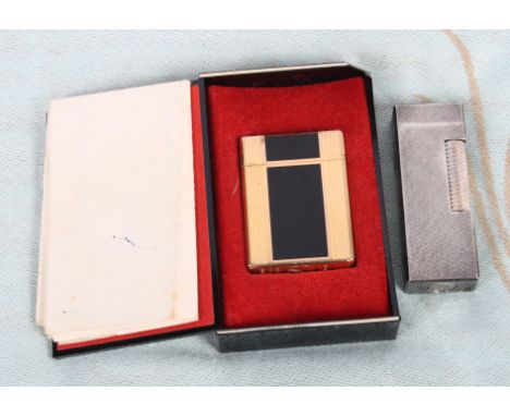 A Dupont gilt metal and black enamelled cigarette lighter with original box and receipt together with a Dunhill white metal c