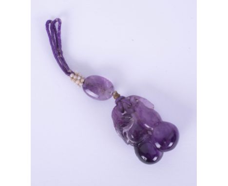 A large carved amethyst drop pendant, length of main carved stone 36mm, 23.35g.