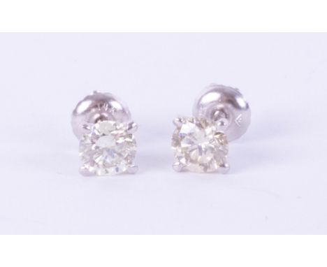 A pair of 14k white gold and diamond earrings, weight 1.09 carat, together with GIE diamond grading report&nbsp; indicating c