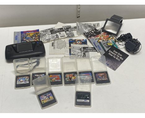 A Sega Game Gear console with chargers &amp; eight assorted games and accessories (untested) 