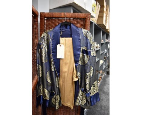 A mid century oriental smokers jacket in blue silk satin having gold thread embroidery with a set of single button fly trouse