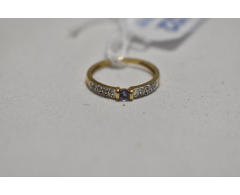 A 9ct gold band ring having small amethyst style stone with diamond chips to shoulders, size L &amp; approx 1.2g