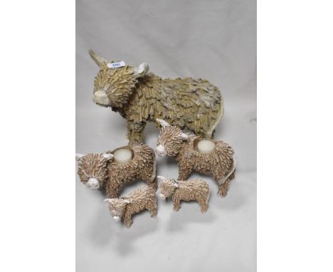 A selection of Highland Cow ornaments including tea light holders