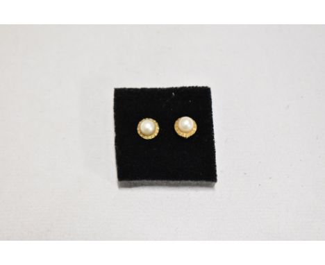A pair of cultured pearl yellow metal stud earrings stamped 18 having screw on butterfly backs,  approx 1.2g