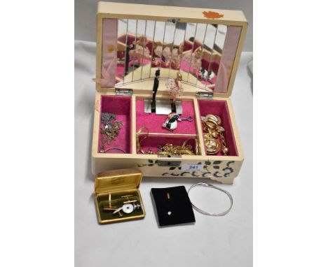 A mid century wooden jewellery box housing a mixed lot of costume jewellery, including chains, stick pin and bracelet.